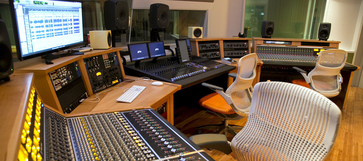 Recording studio featuring racks of equipment and mixing boards at the University of Miami