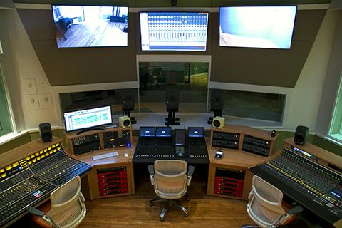 Recording studio featuring racks of equipment and mixing boards at the University of Miami